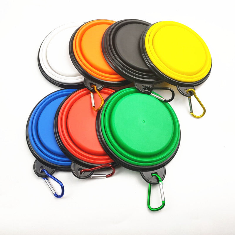 Blue portable folding pet bowl filled with water on a walk