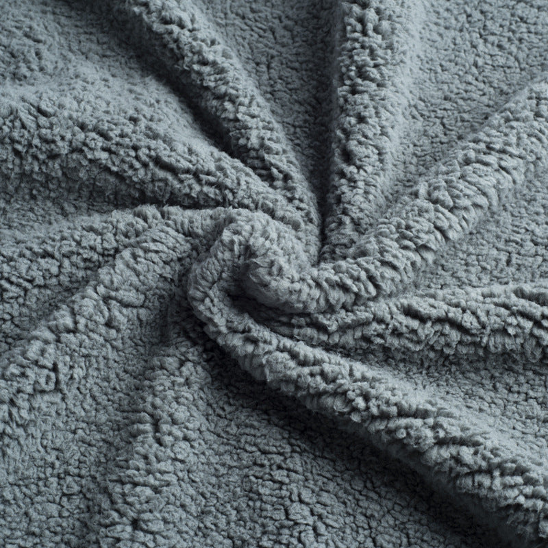Waterproof double-sided pet blanket in grey on a sofa