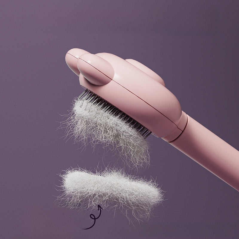 Light blue deshedding comb lifting fur from a cat