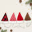 Cat wearing a plush red and white striped Christmas hat