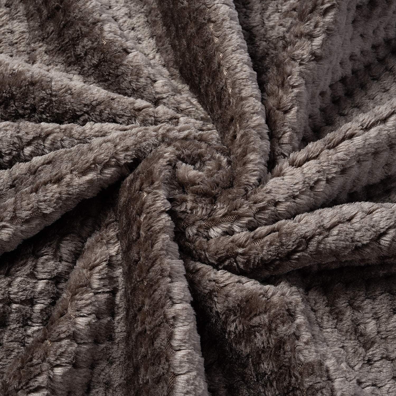 Dusty pink soft pet throw on a sofa