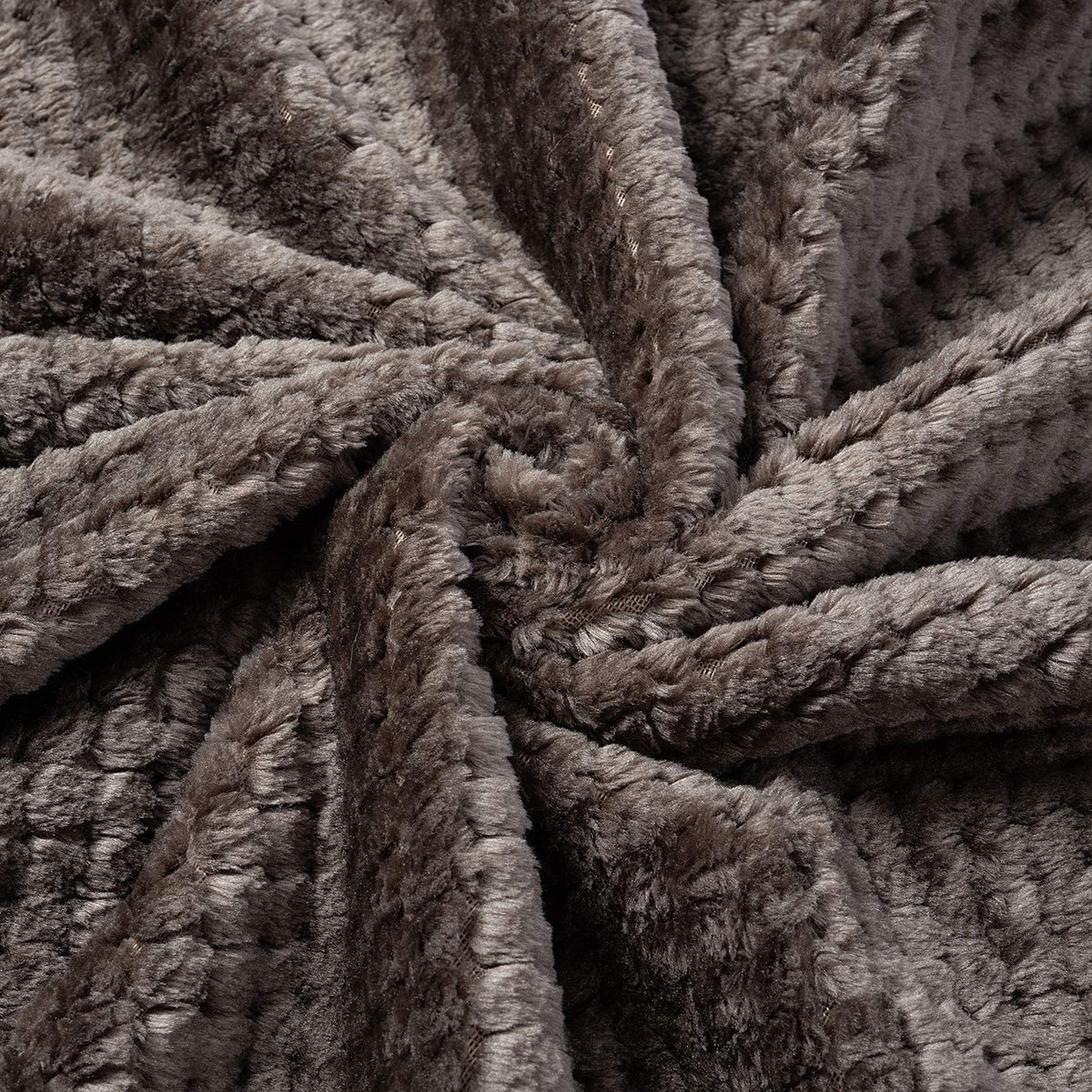 Dusty pink soft pet throw on a sofa