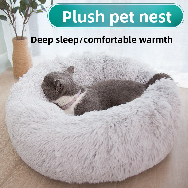 Dog curled up in a dark grey and white round bed