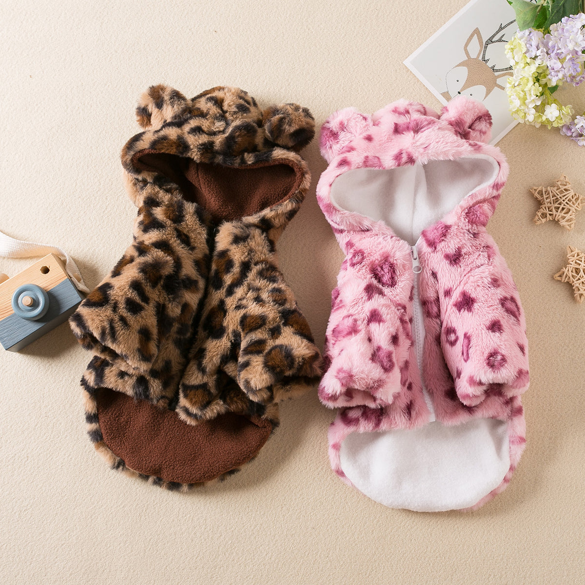 Small dog wearing a pink leopard print plush hoodie