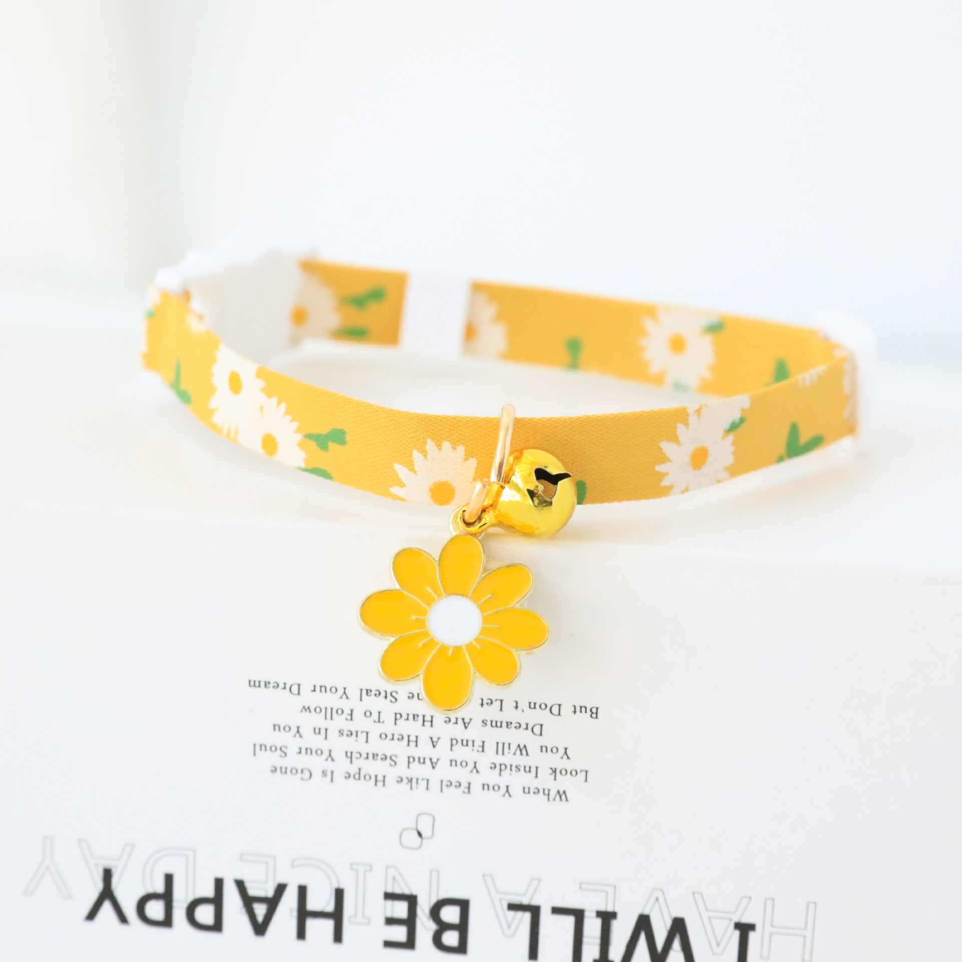 Floral cat collar with bell and safety buckle, showing size and shape