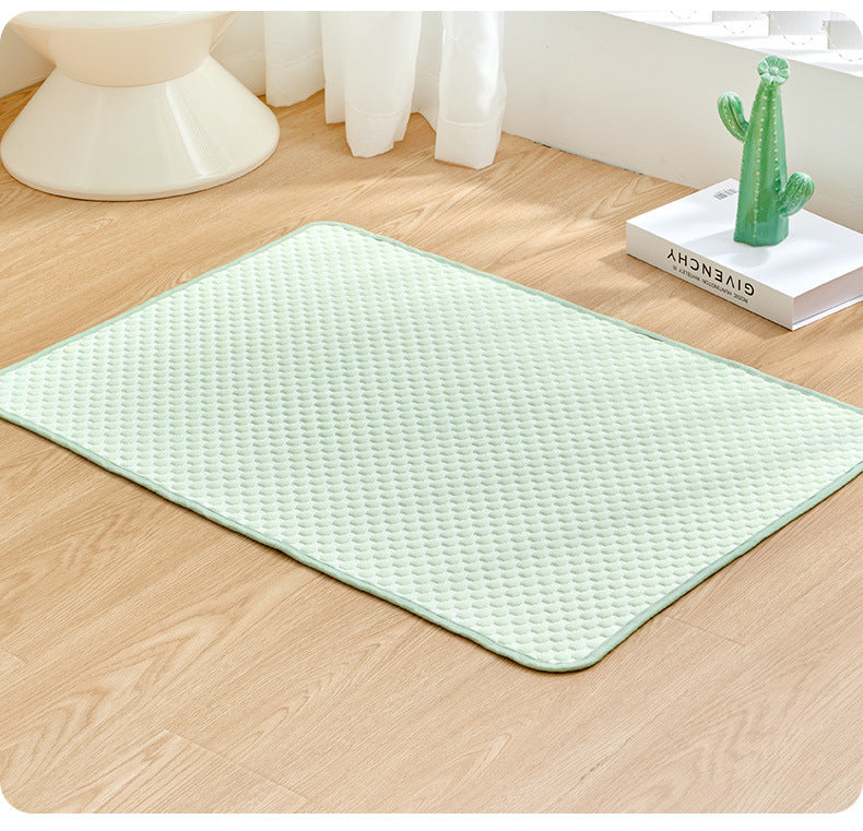 Dog resting on a light green cooling pad