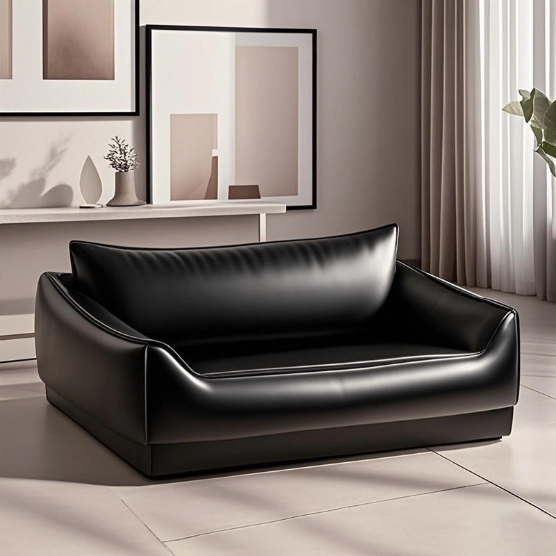 Small dog sitting on a 55 by 45cm faux leather sofa bed
