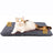 Dog resting on a white thick pet bed mat outdoors