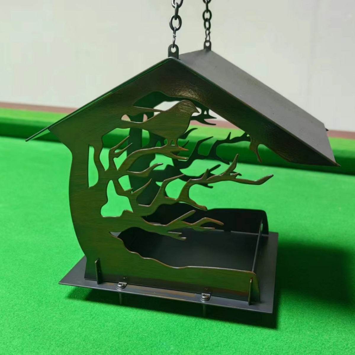 Geometric metal hanging bird feeder for gardens, close-up detail view