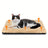 Dog resting on a white thick pet bed mat outdoors