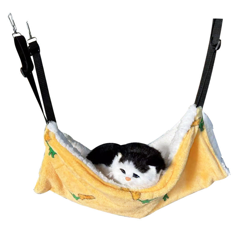 Cat lounging in a strawberry pattern cage hammock