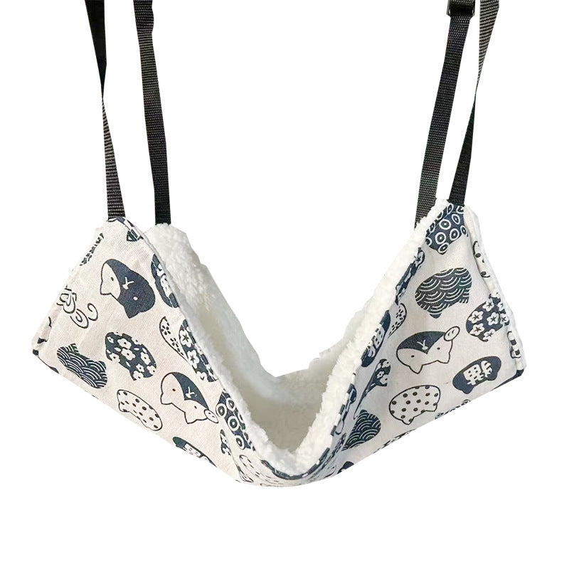 Blue cat print hanging hammock hooked inside a crate