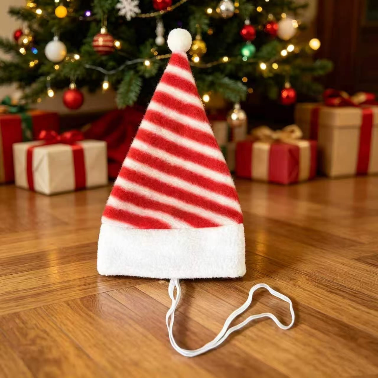 Cat wearing a plush red and white striped Christmas hat