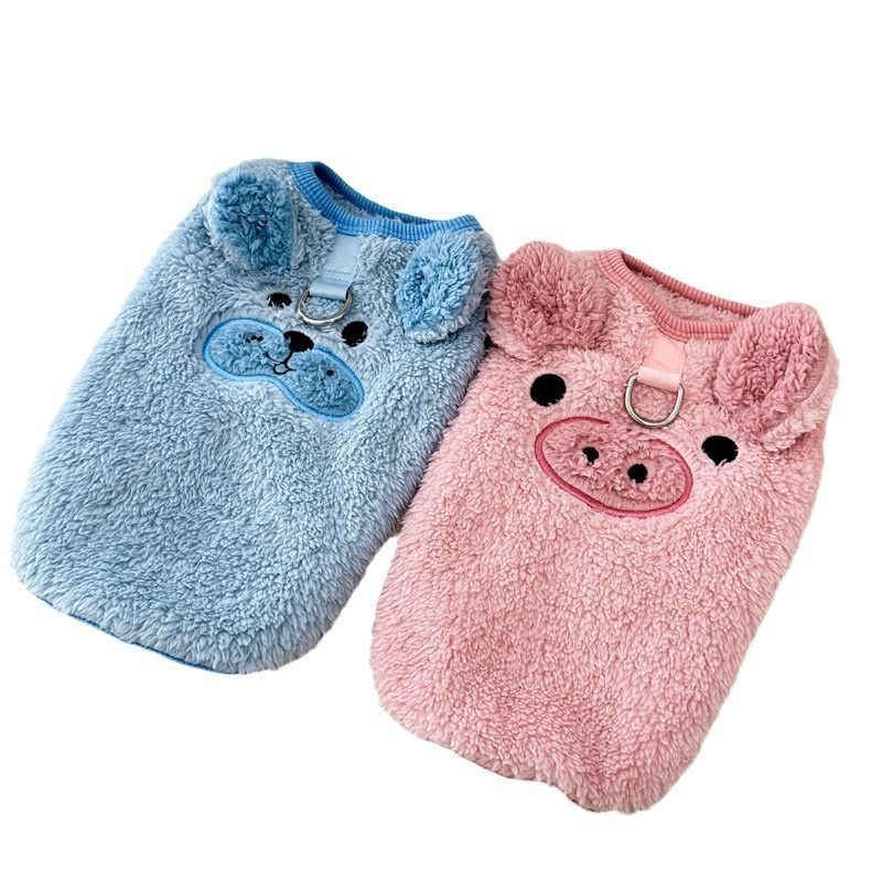 Small dog in a pink fleece lined jumper with piglet embroidery