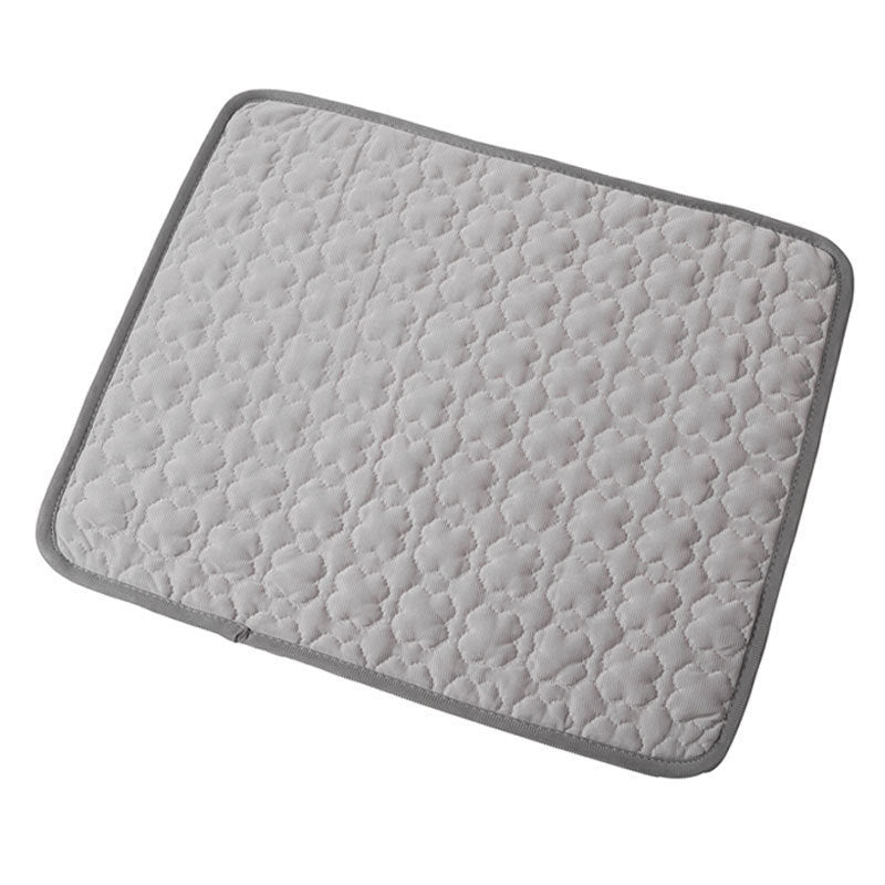 Cat stretched out on a grey breathable cooling mat