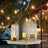 Metal swing garden bird feeder hanging outdoors, view 1