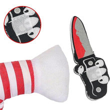 Small dog in a spooky Halloween costume with prop knife