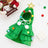 Cat wearing a red Christmas tree pattern cloak