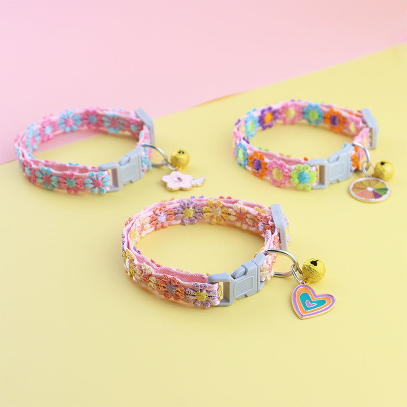 Blue and pink feather collar with bell on a cat