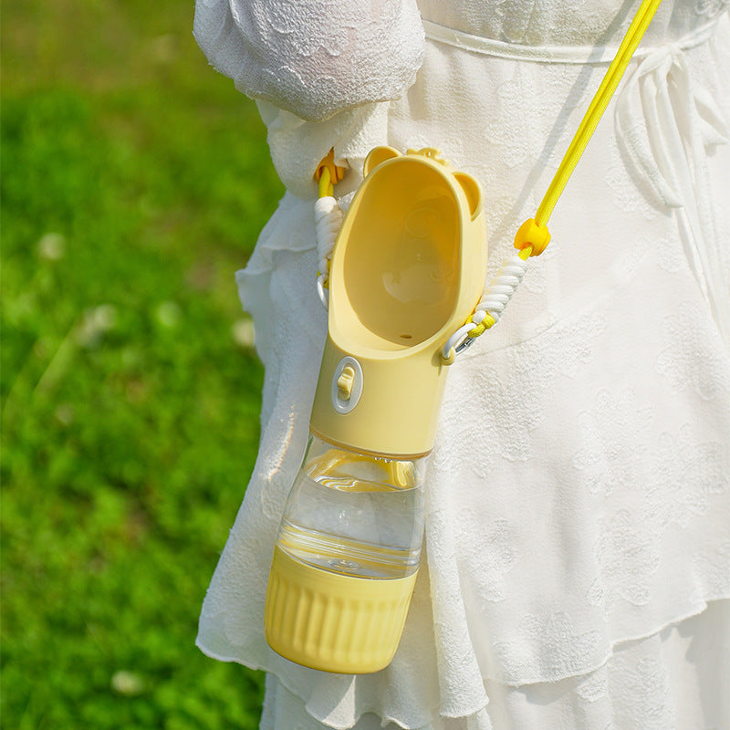 Portable dog water and food cup with strap, close-up detail view