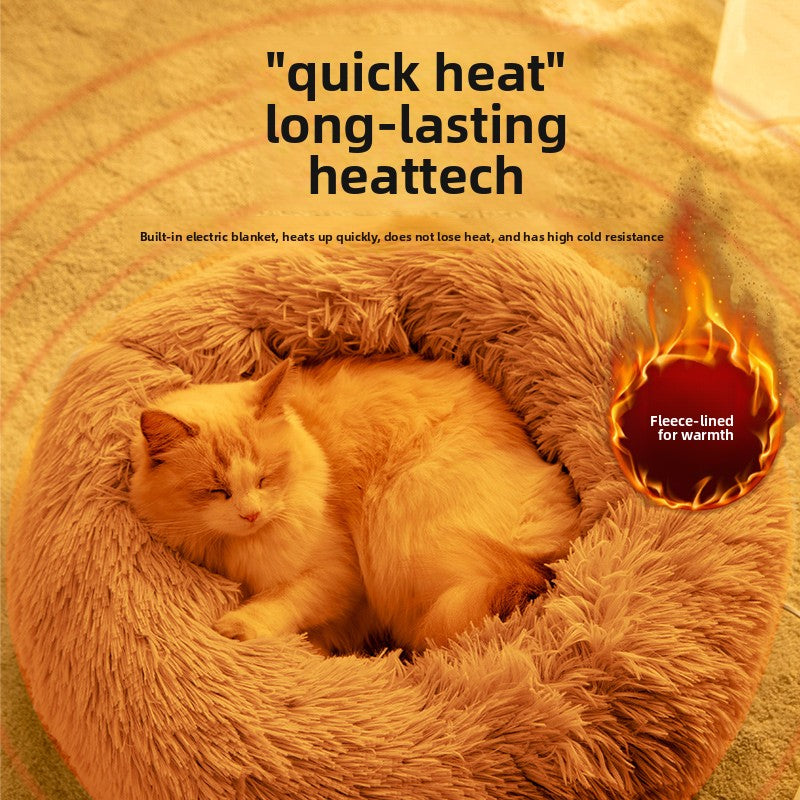 Cat sleeping in a round electric warming bed in winter