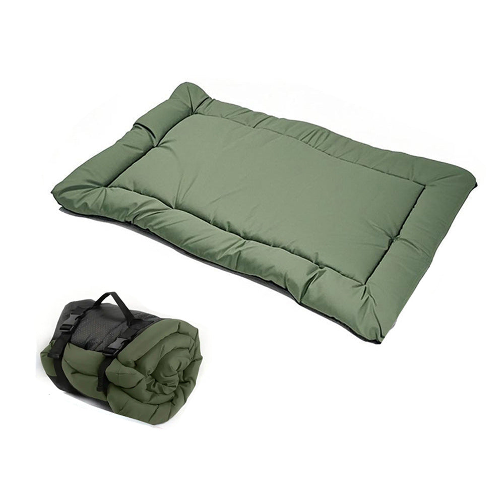 Army green foldable dog mat laid out on grass