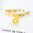 Floral cat collar with bell and safety buckle in Yellow, in a home setting