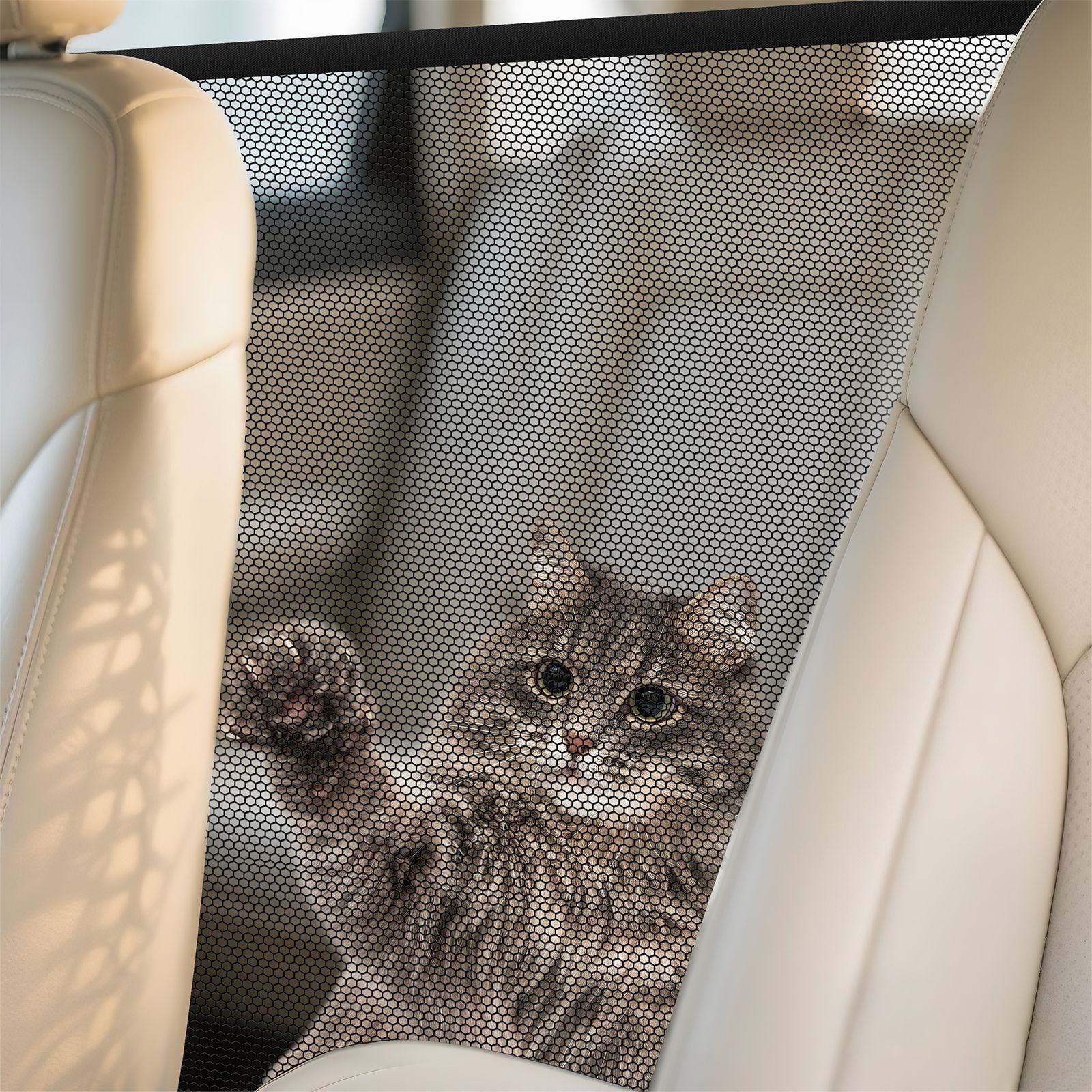 Black nylon mesh divider keeping a dog on the back seat
