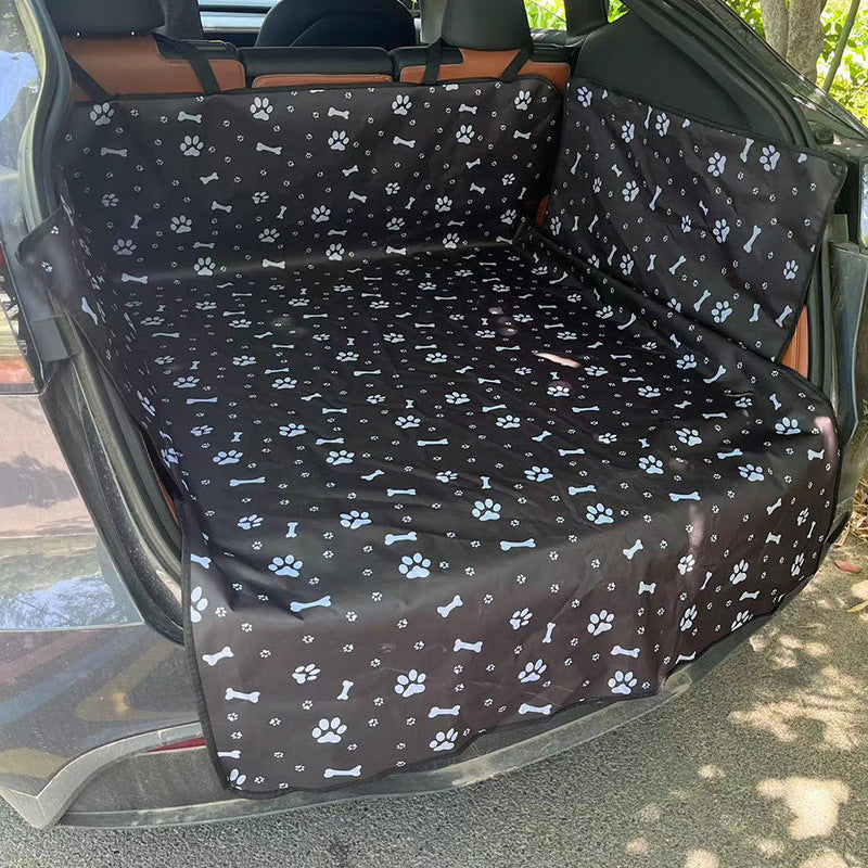 Dog sitting on a black edge boot liner in the car
