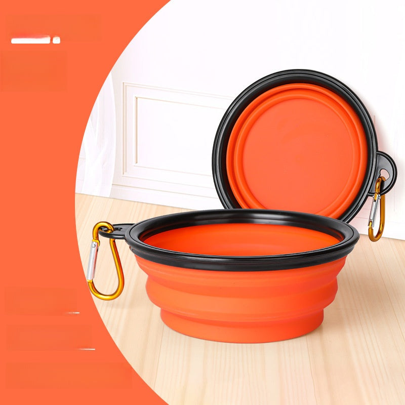 Collapsible pet travel bowl with clip in Red, in use with a pet