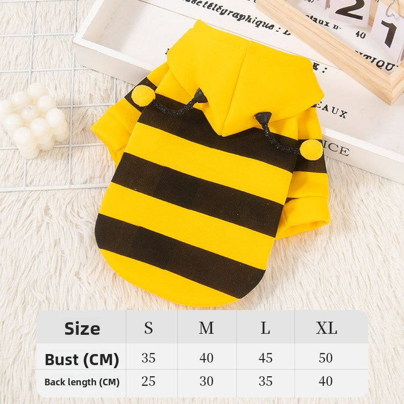Small dog wearing a yellow and black striped bee sweatshirt