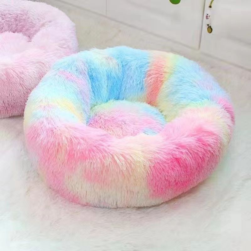 Cat sleeping in a pink USB warming nest