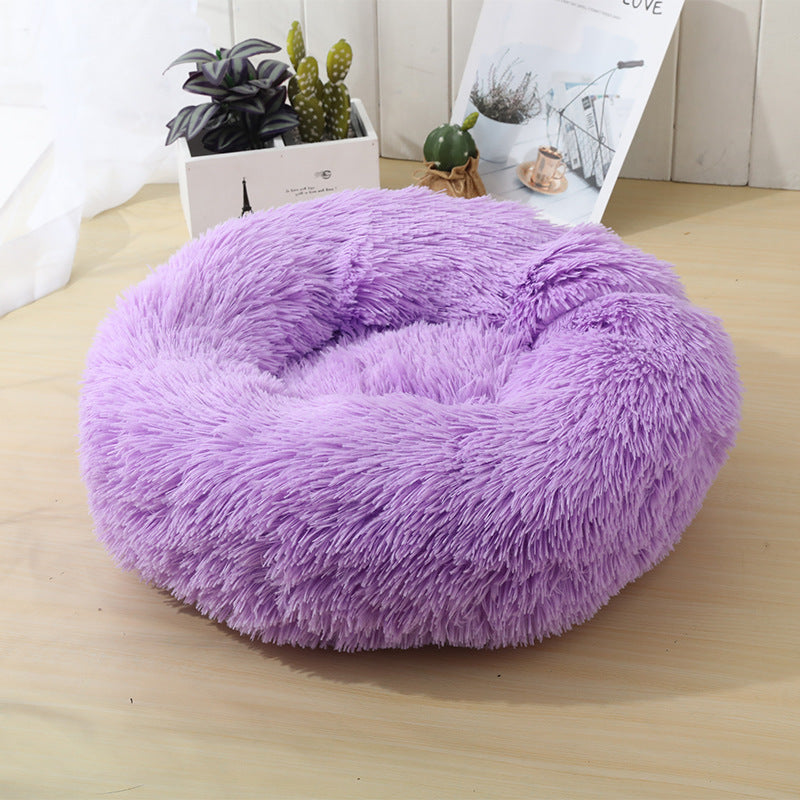Cat sleeping in a pink USB warming nest