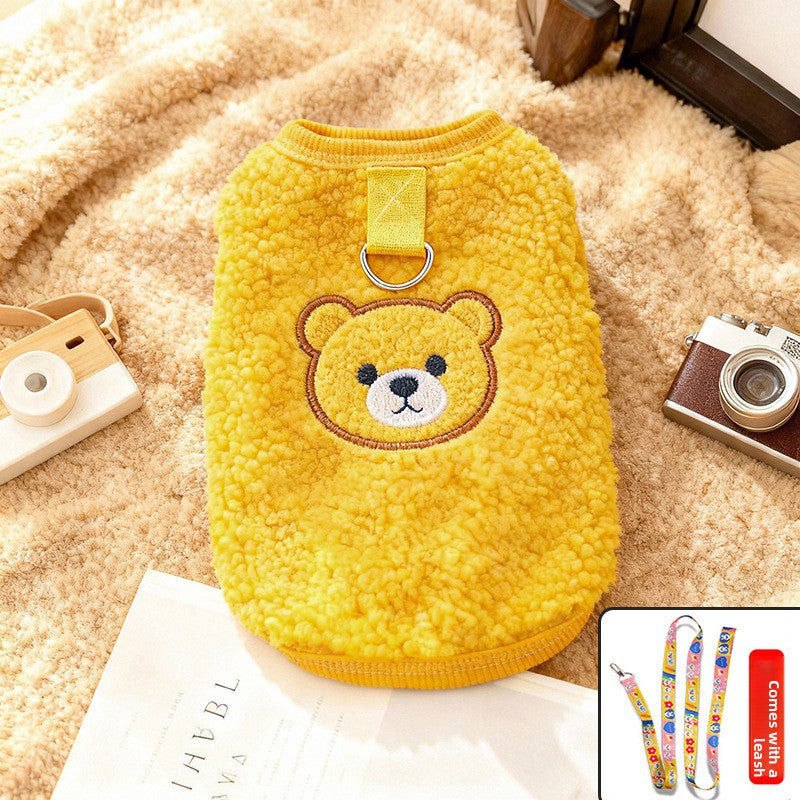 Small dog wearing a cosy blue sherpa fleece bear vest