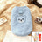 Small dog wearing a cosy blue sherpa fleece bear vest