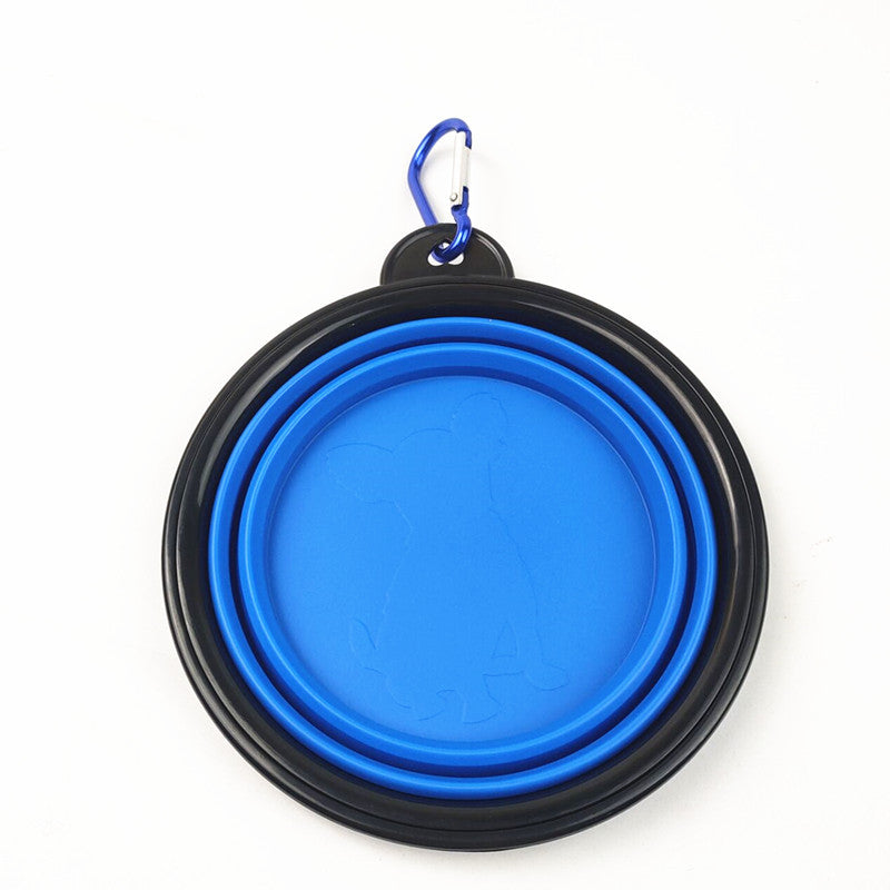 Blue portable folding pet bowl filled with water on a walk