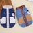 Fleece lined denim pet jacket with panda design, in a home setting