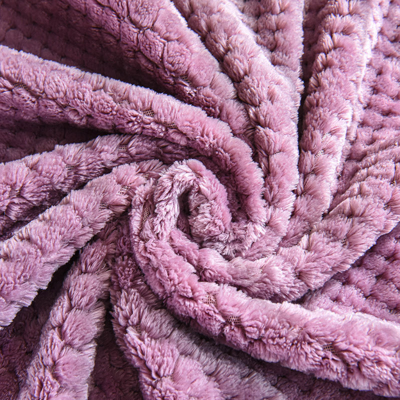 Dusty pink soft pet throw on a sofa