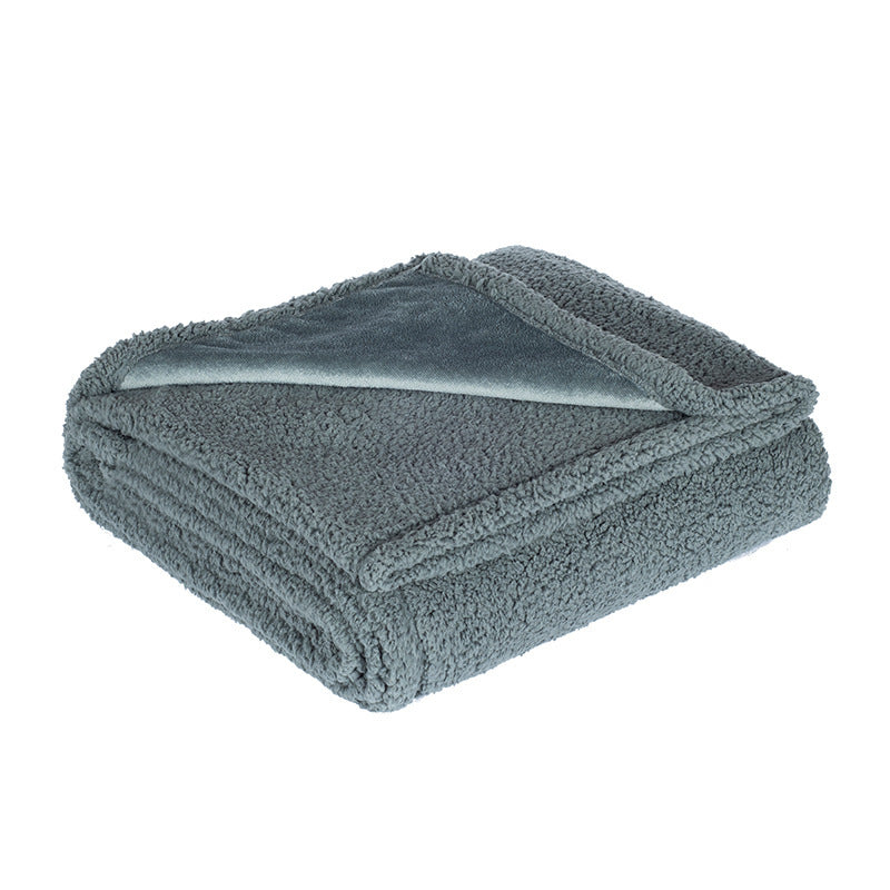 Waterproof double-sided pet blanket in grey on a sofa