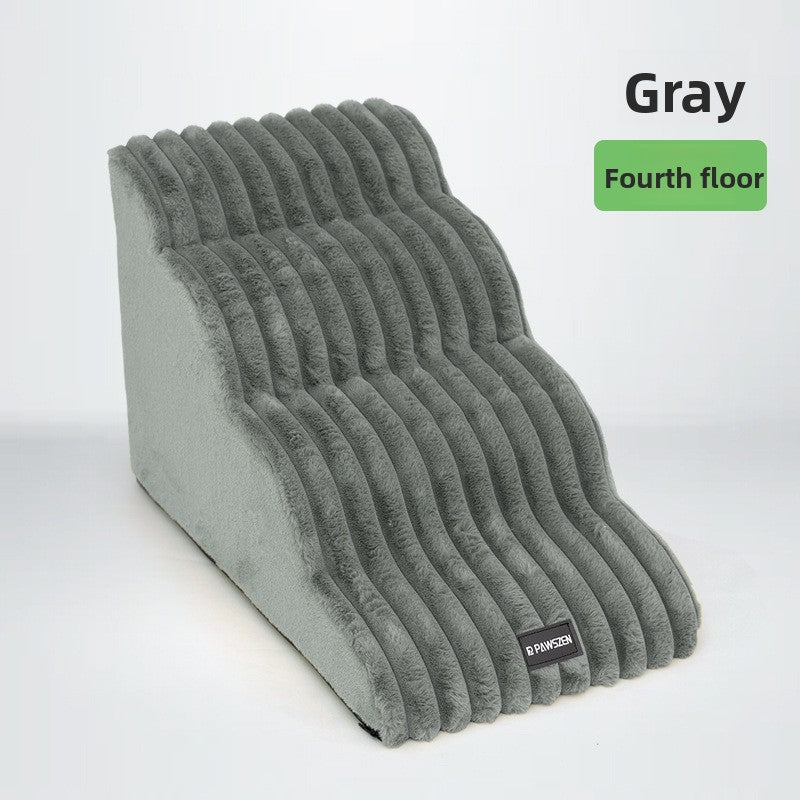 Grey two-step foam dog steps beside a bed