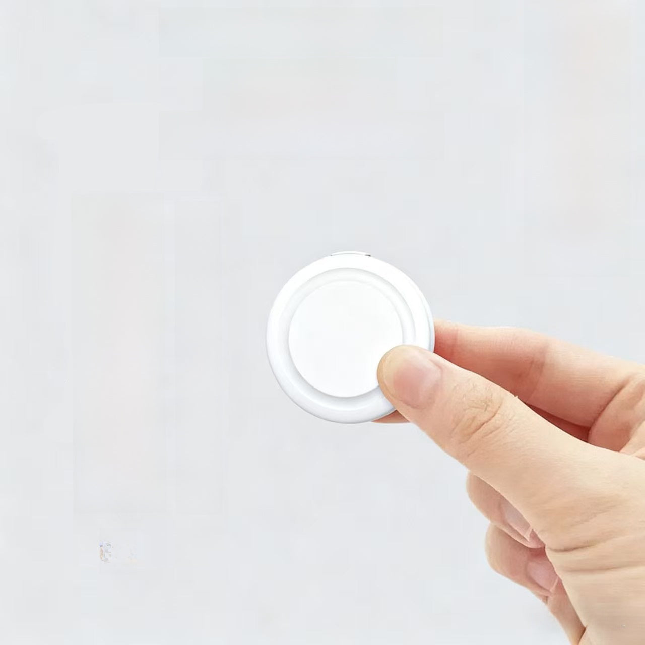 Compact white Bluetooth pet locator tag with silicone case, product image 2