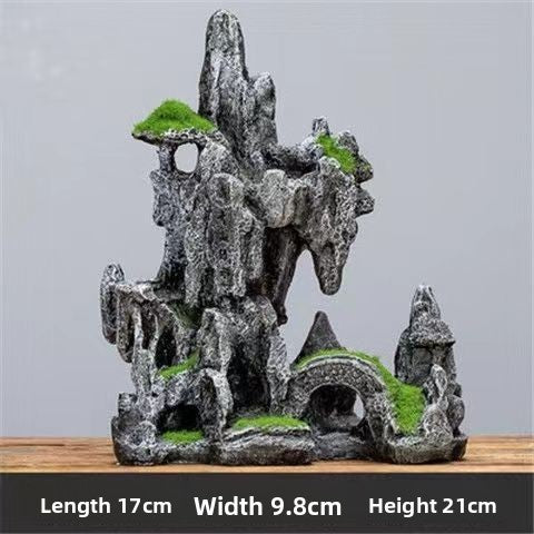 Fish swimming past a snow mountain rock decoration