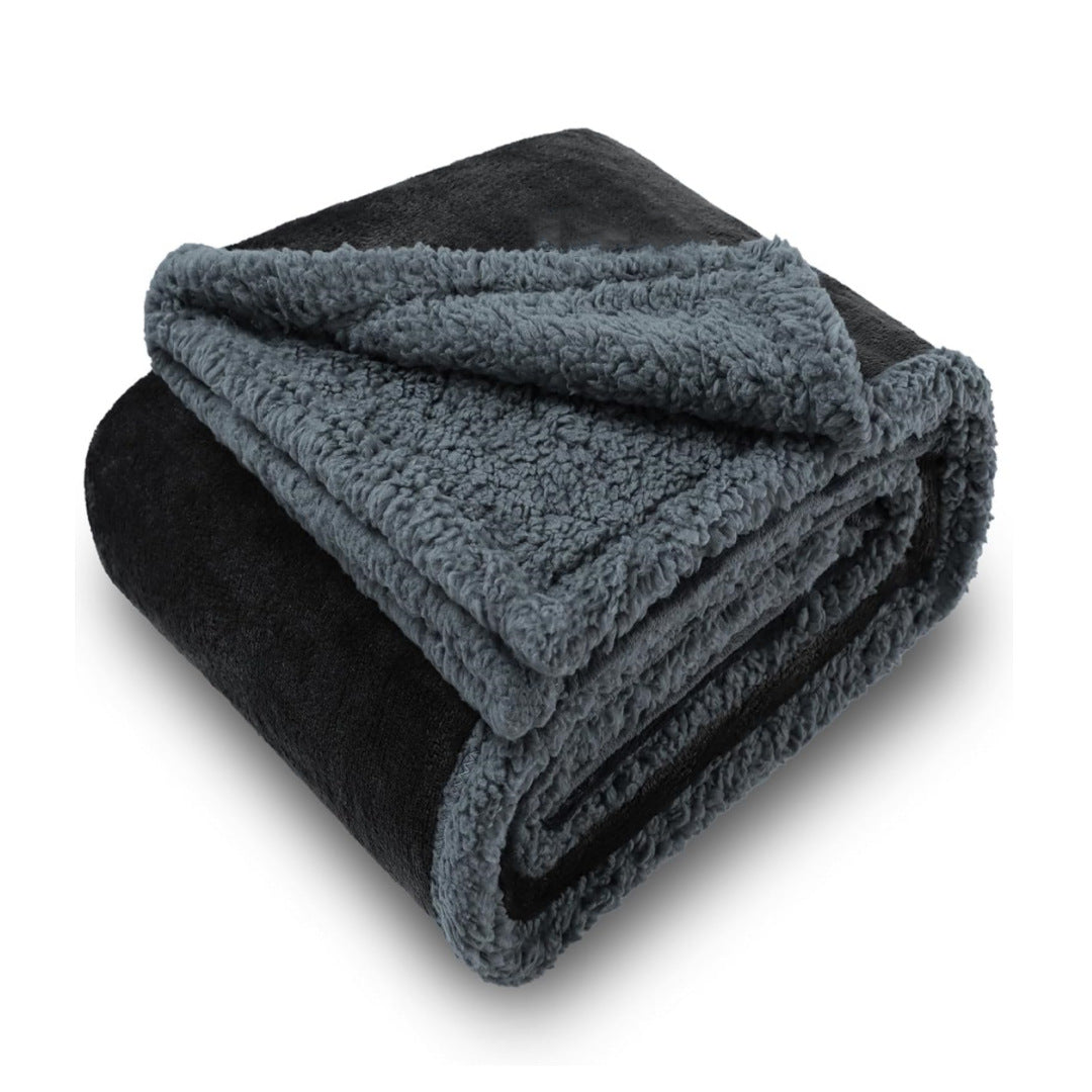 Waterproof double-sided pet blanket in grey on a sofa