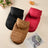 Small dog in a black hooded fleece lined vest jacket