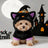 Cat wearing a pumpkin ghost Halloween costume with plaid detail